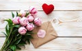 Bouquet of pink tulips, envelope and red heart on white wooden background, Valentines Day, International Women's Day, Mothers day Royalty Free Stock Photo