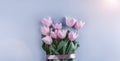 Bouquet of pink tulips flowers on blue background. Waiting for spring. Greeting card or wedding invitation. Royalty Free Stock Photo