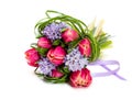 Bouquet of pink tulips and grass on green background