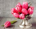 Bouquet of pink tulips in metal vase on wooden background Royalty Free Stock Photo