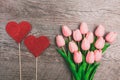 Bouquet of pink tulips and red two hearts from paper, on wooden background Royalty Free Stock Photo