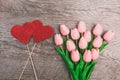 Bouquet of pink tulips and red two hearts from paper, on wooden background Royalty Free Stock Photo