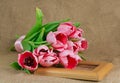 A bouquet of pink tulips with satin ribbon lying on the frame Royalty Free Stock Photo