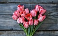 Bouquet of pink tulips in the shape of a heart on a wooden background Royalty Free Stock Photo