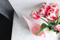 Bouquet of pink tulips and watering pot at home top view, indoor. Beautiful flowers, lifestyle. Holiday congratulation Royalty Free Stock Photo