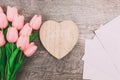 Bouquet of pink tulips and white blank envelopes, on wooden background Royalty Free Stock Photo