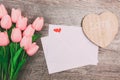Bouquet of pink tulips and white blank envelopes, on wooden background Royalty Free Stock Photo