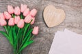 Bouquet of pink tulips and white blank envelopes, on wooden background Royalty Free Stock Photo