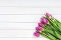 Bouquet of pink tulips on white wooden background. Top view Royalty Free Stock Photo