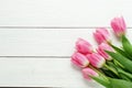 A bouquet of pink tulips on a white wooden background Royalty Free Stock Photo