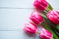 Bouquet of pink tulips on wooden background. Flat lay, top view, copy space. Royalty Free Stock Photo