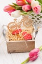 Bouquet of pink tulips, wooden bike, red hearts