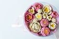 A bouquet of pink and white flowers made from soap. Flowers are collected in a round pink box with a pink ribbon. Place Royalty Free Stock Photo