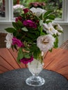 A bouquet of pink and white roses in a crystal glass vase on the table. Royalty Free Stock Photo