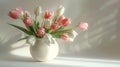 Bouquet of pink and white tulips in a white vase on a light background, elegant floral arrangement. Spring and freshness