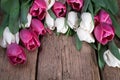 A bouquet of pink and white tulips on a wooden table. Spring flowers. Creation of cards for Valentine`s Day, Mother`s Day and Royalty Free Stock Photo