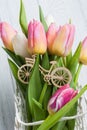 Bouquet of pink yellow tulips and wooden bike