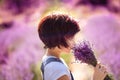 Bouquet portrait of happy cute little girl with bob haircut sniffing lavender bouquet in lavender field with purple flowers around Royalty Free Stock Photo