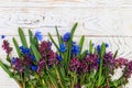 Bouquet of purple corydalis flowers and blue scilla flowers on white wooden background Royalty Free Stock Photo