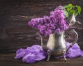 Lilac flowers in decorative vintage teapot