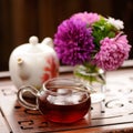 Bouquet of purple and pink asters and black tea on carved tea tr Royalty Free Stock Photo