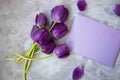 Bouquet of purple tulips along a love letter