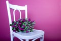 Bouquet of purple tulips on white chair Royalty Free Stock Photo