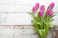 Bouquet of purple tulips on white wooden background. Top view Royalty Free Stock Photo