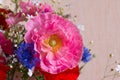 Bouquet of red and pink poppy and blue cornflower on light background close up. Summer flowers background.