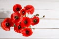 Bouquet of red poppies in glass vase on old white wooden table Royalty Free Stock Photo