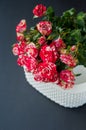 Bouquet of red roses against brick wall background in glass vase  with heart shape petals and red gift box  ribbons  passion love Royalty Free Stock Photo