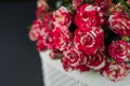 Bouquet of red roses against brick wall background in glass vase  with heart shape petals and red gift box  ribbons  passion love Royalty Free Stock Photo