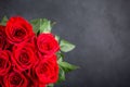 Bouquet of red roses.  Beautiful flowers on a black background. Top view, copy space Royalty Free Stock Photo