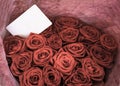 Bouquet of red roses with blank message sign for your text or message