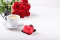 Bouquet of red roses, cup of coffee and heart shaped pink cake. Copy space. Happy Valentines day Royalty Free Stock Photo