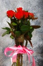 Bouquet red roses flower in glass vase on gray background