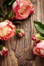 Red roses bouquet with petals on wooden backdrop Royalty Free Stock Photo