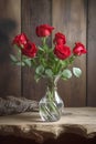 bouquet of red roses in glass vase on wooden background Royalty Free Stock Photo