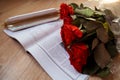 A bouquet of red roses lies on a Spanish textbook Royalty Free Stock Photo