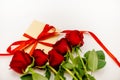 Bouquet of red roses with a red ribbon and an evelope