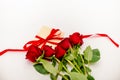 Bouquet of red roses with a red ribbon and an evelope