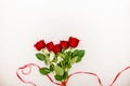 Bouquet of red roses with a red ribbon and an evelope