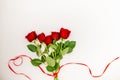 Bouquet of red roses with a red ribbon and an evelope