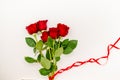 Bouquet of red roses with a red ribbon and an evelope