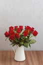 Bouquet of red roses in vase, greeting card template with empty space for text Royalty Free Stock Photo