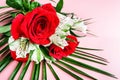 Bouquet of red roses with white flowers on a pink background Royalty Free Stock Photo