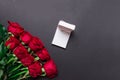 Bouquet of red roses and white opened gift box on black background, with copy space Royalty Free Stock Photo