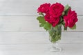 Bouquet of red roses on white wooden background, copy space. Royalty Free Stock Photo
