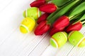 Bouquet red tulip flowers with easter eggs on old wooden table Royalty Free Stock Photo