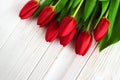 Bouquet red tulip flowers on old wooden table. Background. Eas Royalty Free Stock Photo